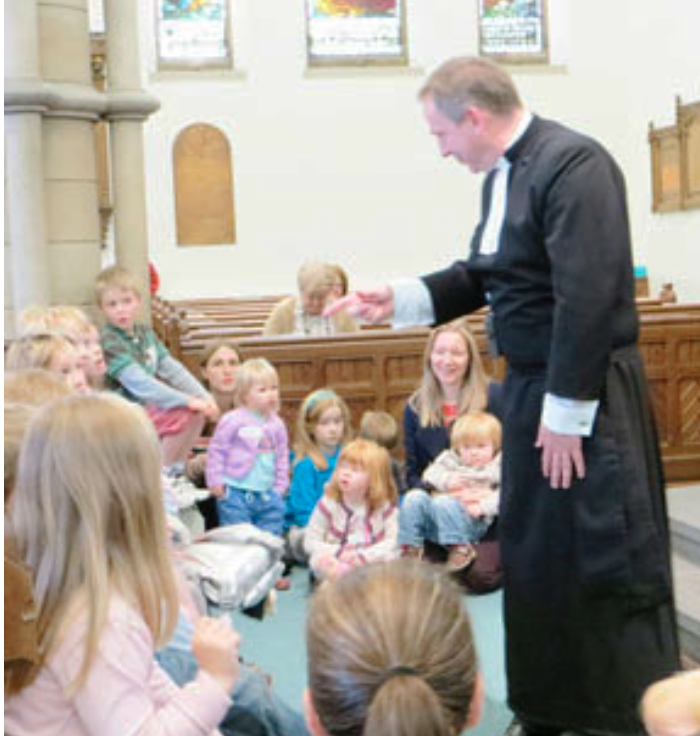 Rev McKenna with mothers and children