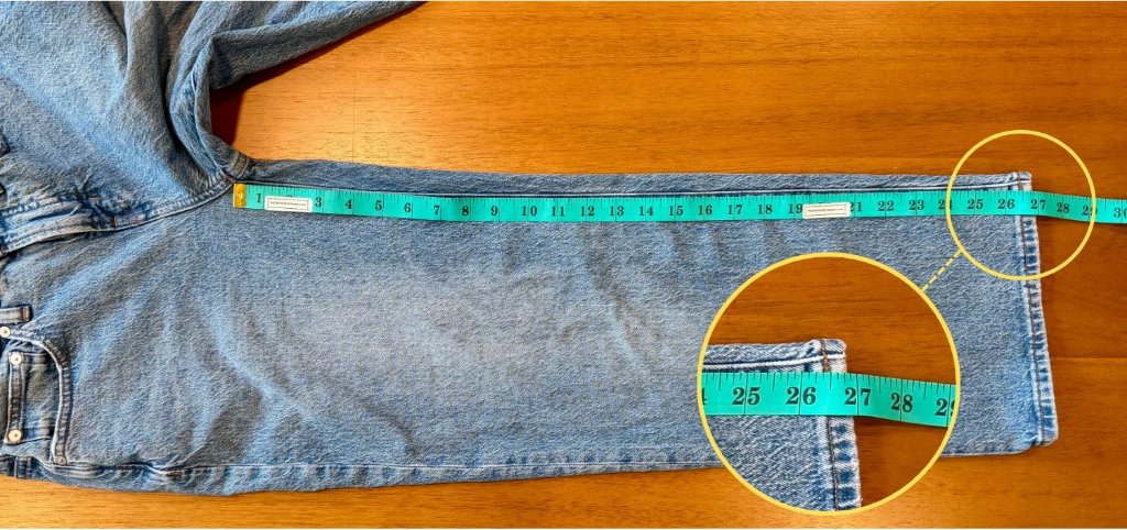 Measuring the inseam of a pair of jeans with a flexible tape measure