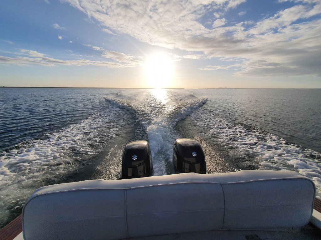 Twin outboards and wake at sunset, Coronet 21DC, Maputo