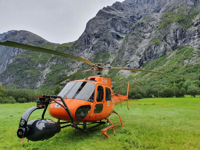Aerial filming helicopter in mountains