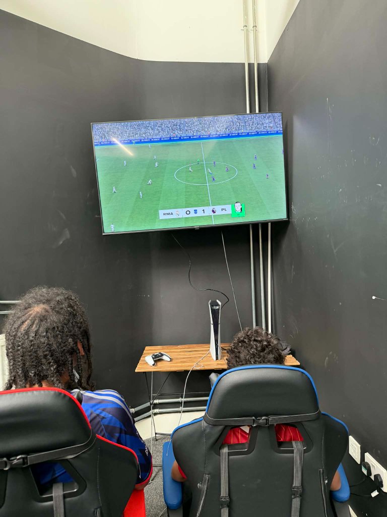 Young gamers playing FC on PS5 at Victory Gaming venue