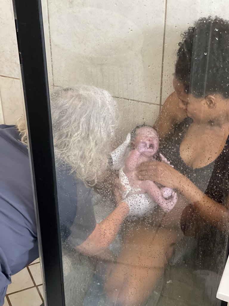 Newborn baby with caregiver