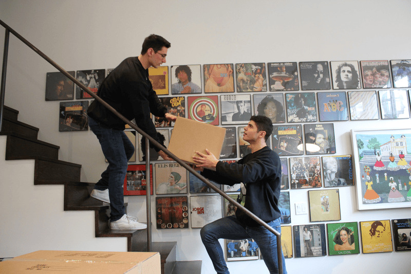 Professional NYC movers relocating furniture and boxes in New York City apartment - Serenity Movers