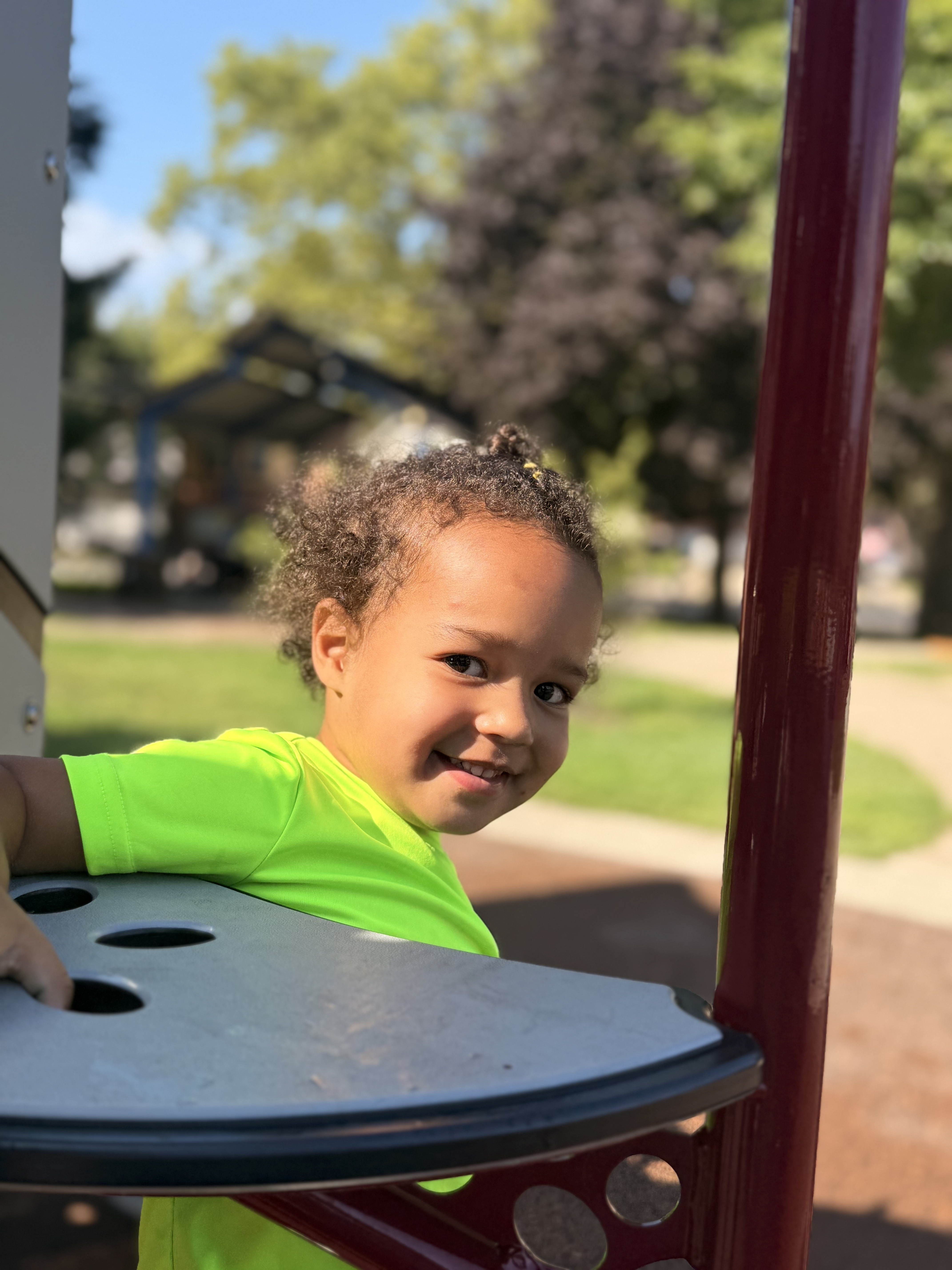 Child looking back at the camera at the playground