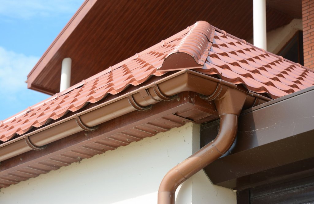 Home exterior showing roof and gutter damage from storm