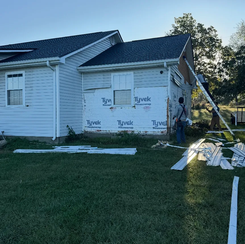 House mid-siding installation with housewrap exposed
