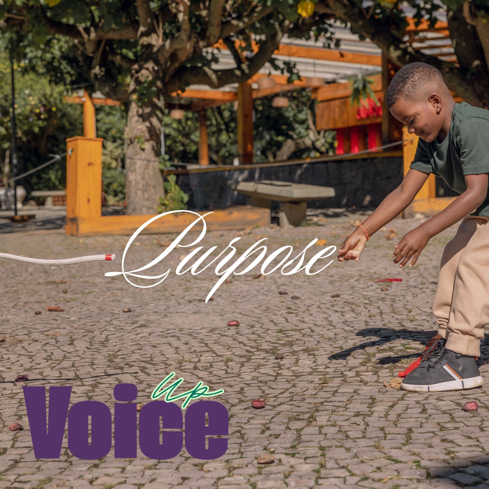 Purpose. A young boy reaches out toward a rope outdoors. Voice Up.