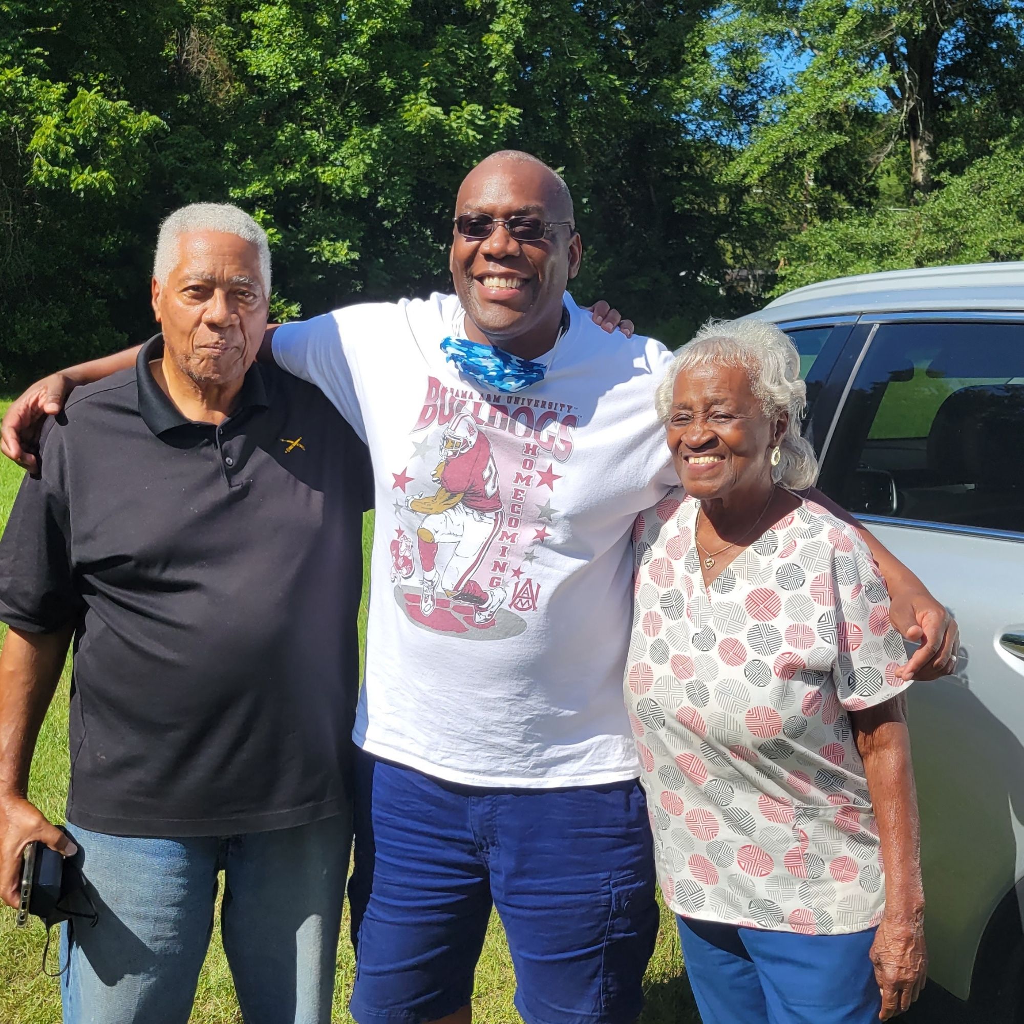 Art Fuller with family at a sunny outdoor gathering — Fuller Road, Montgomery, Alabama