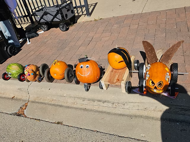 Row of creatively decorated pumpkin racers
