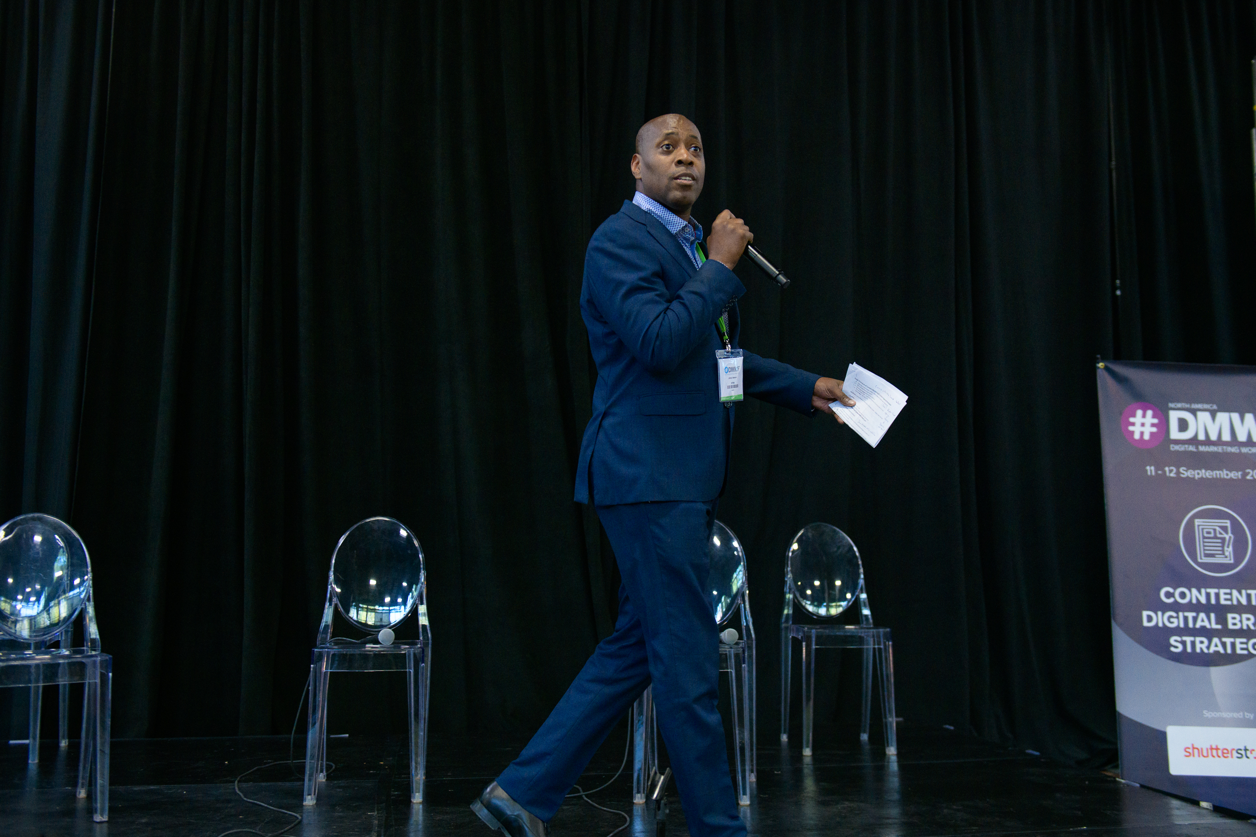 Jimmy Newson speaking on stage at DMWF North America
