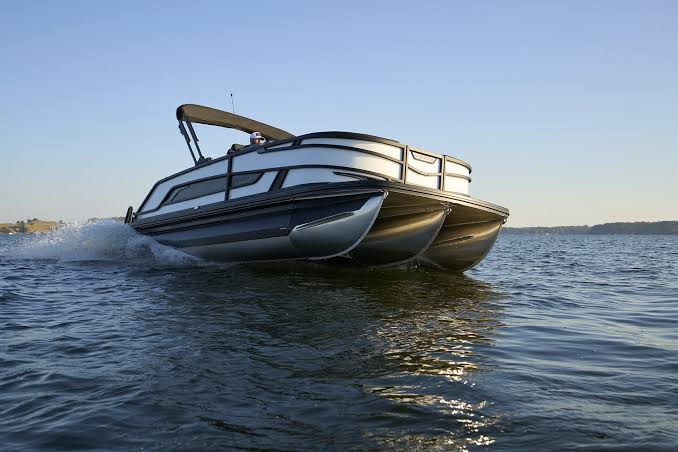 Tritoon boat on open water