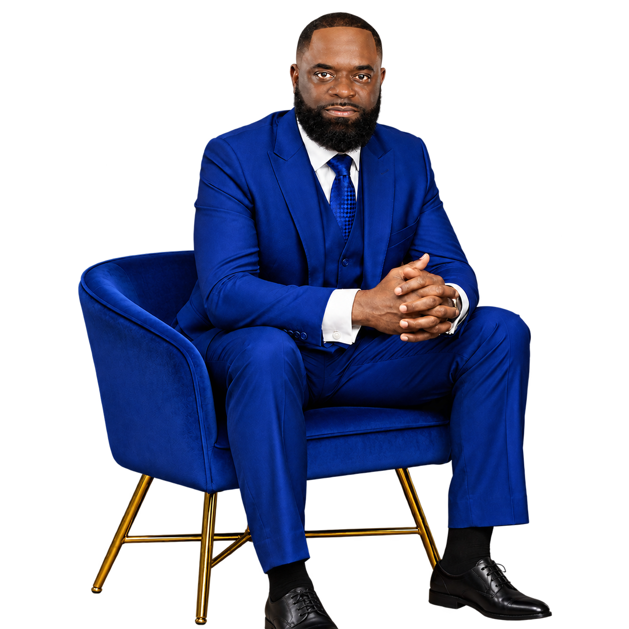 Apostle Edwin A. Newsome, Senior Pastor, seated in a royal blue suit in a velvet armchair