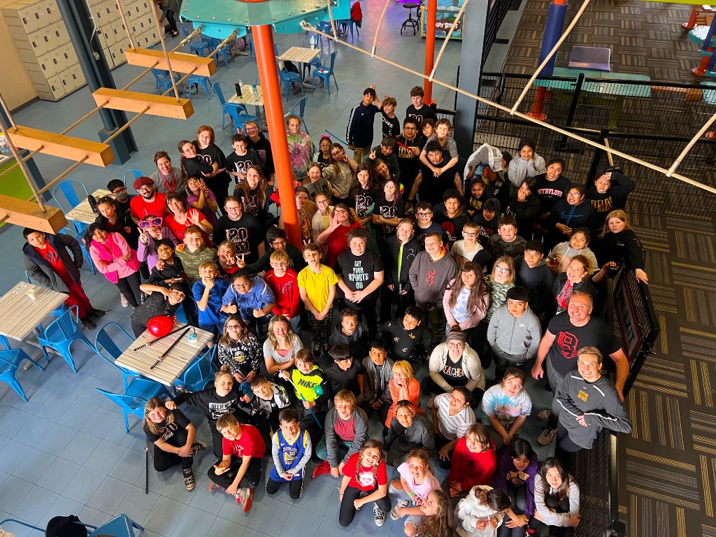 Large group of students gathered at Allegan Event adventure center