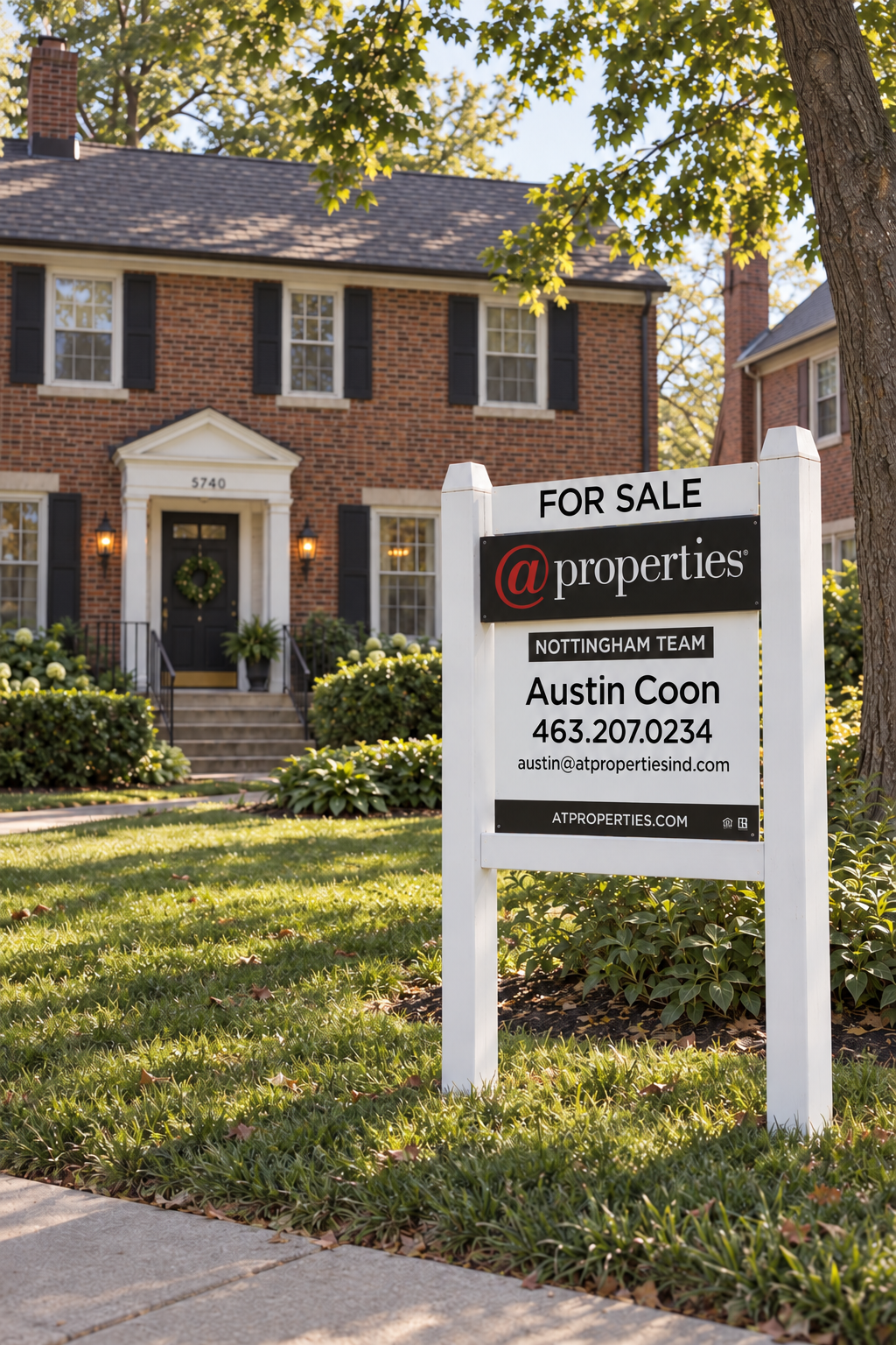 Austin Coon's @properties For Sale sign in front of a brick Indianapolis home