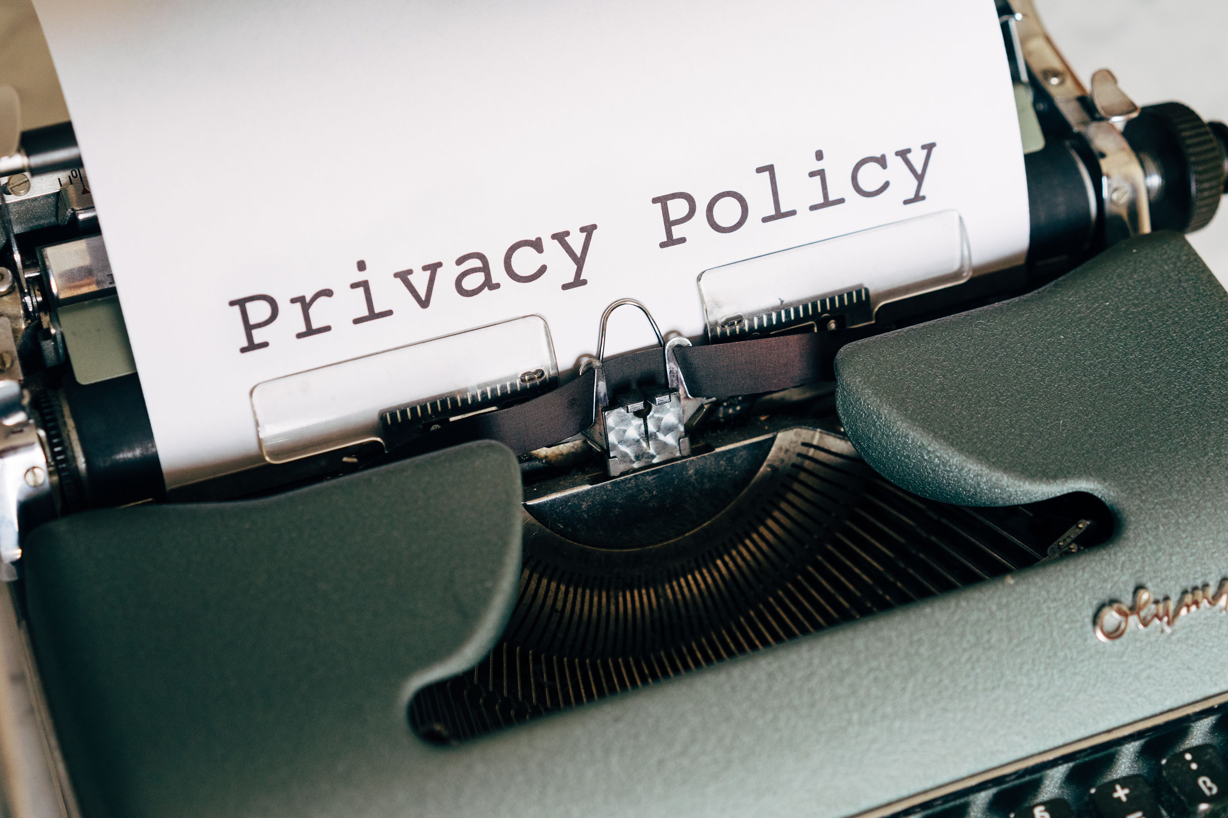 A vintage typewriter with the words Privacy Policy typed on paper