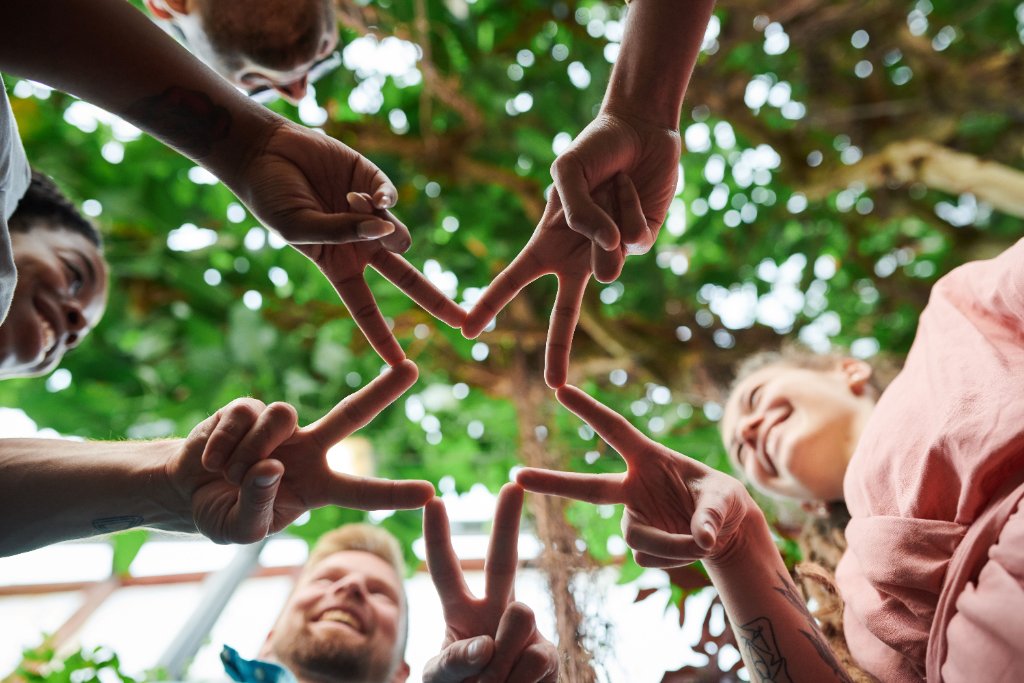 Community members forming a star with their hands