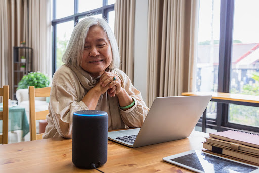 Senior woman setting up Amazon Alexa at home