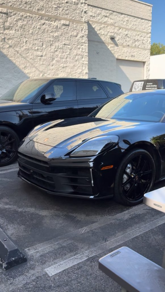 Black Porsche with mirror-like reflective paint after a Polish Theory decon and wax