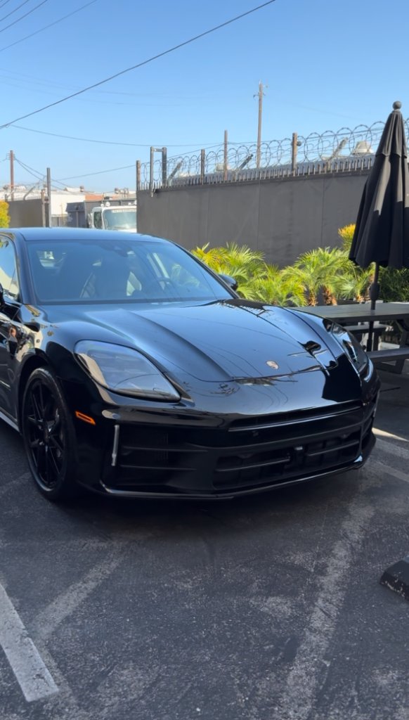 Glossy, contaminant-free black paint after an exterior decon and wax detail
