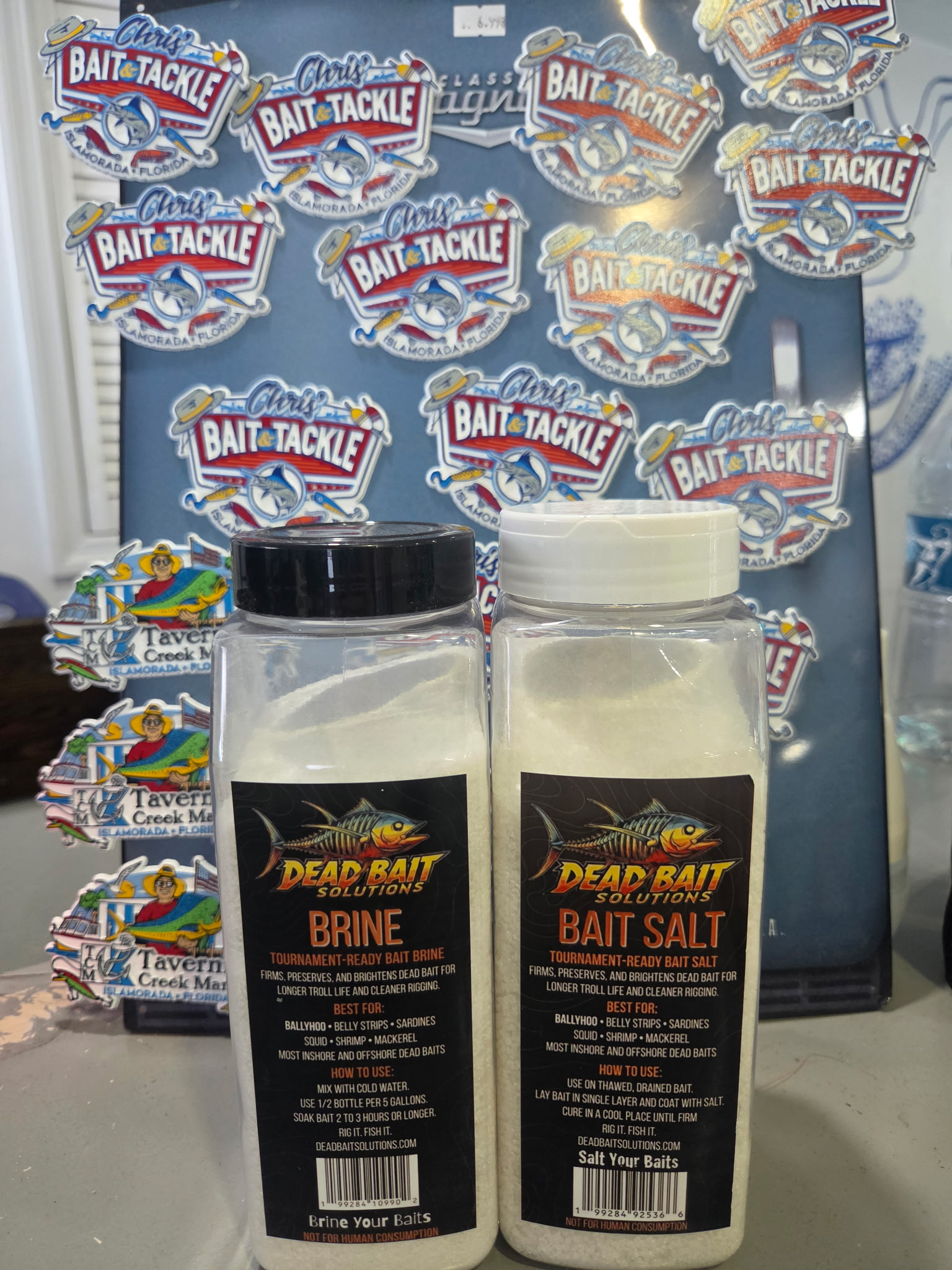 Dead Bait Solutions Brine and Bait Salt bottles on the shelf at Chris's Bait and Tackle, Tavernier Creek Marina, Islamorada, Florida