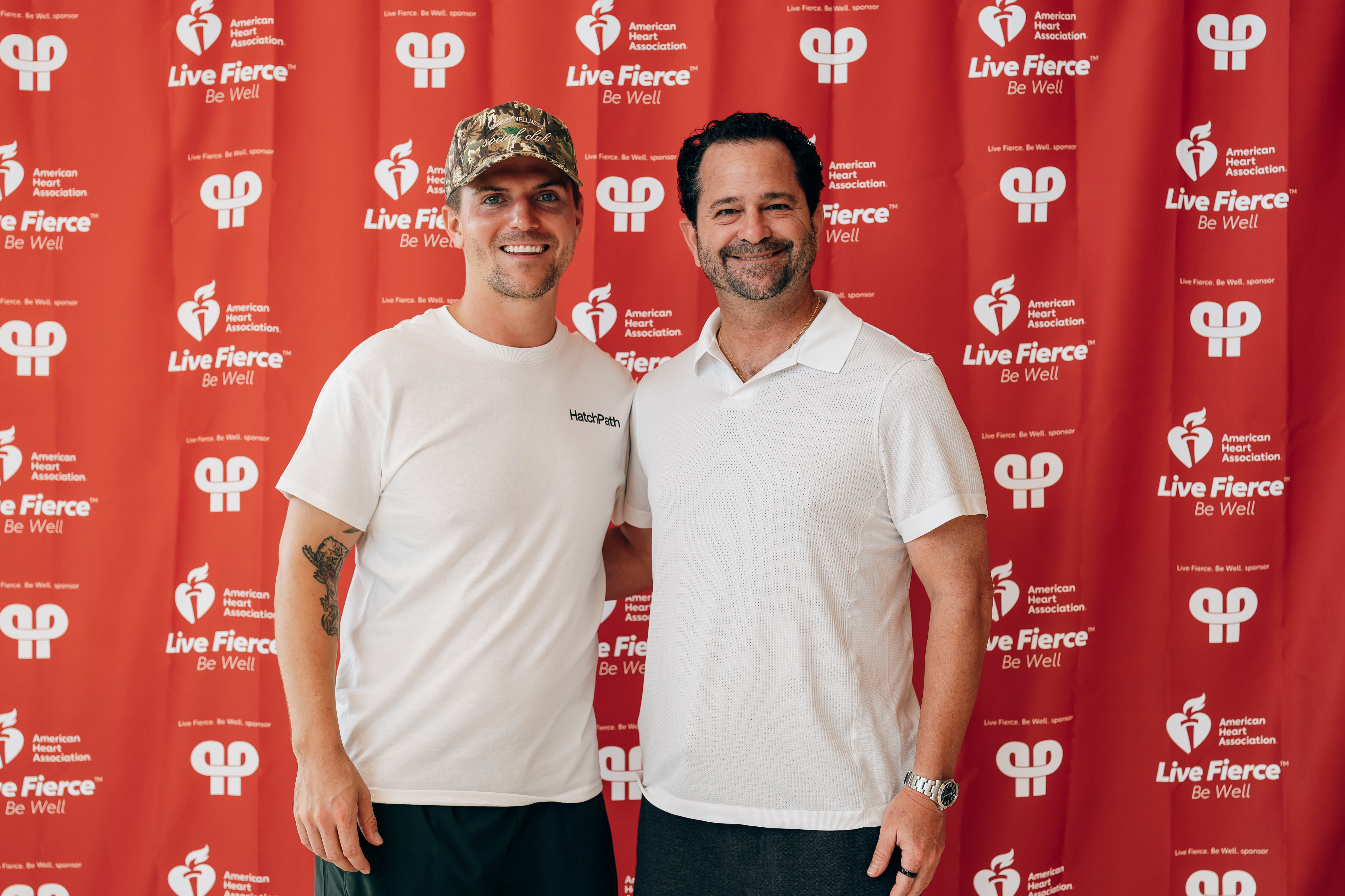 Friends of the cause in front of the American Heart Association backdrop.