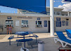 Admissions building with blue signage and patio seating