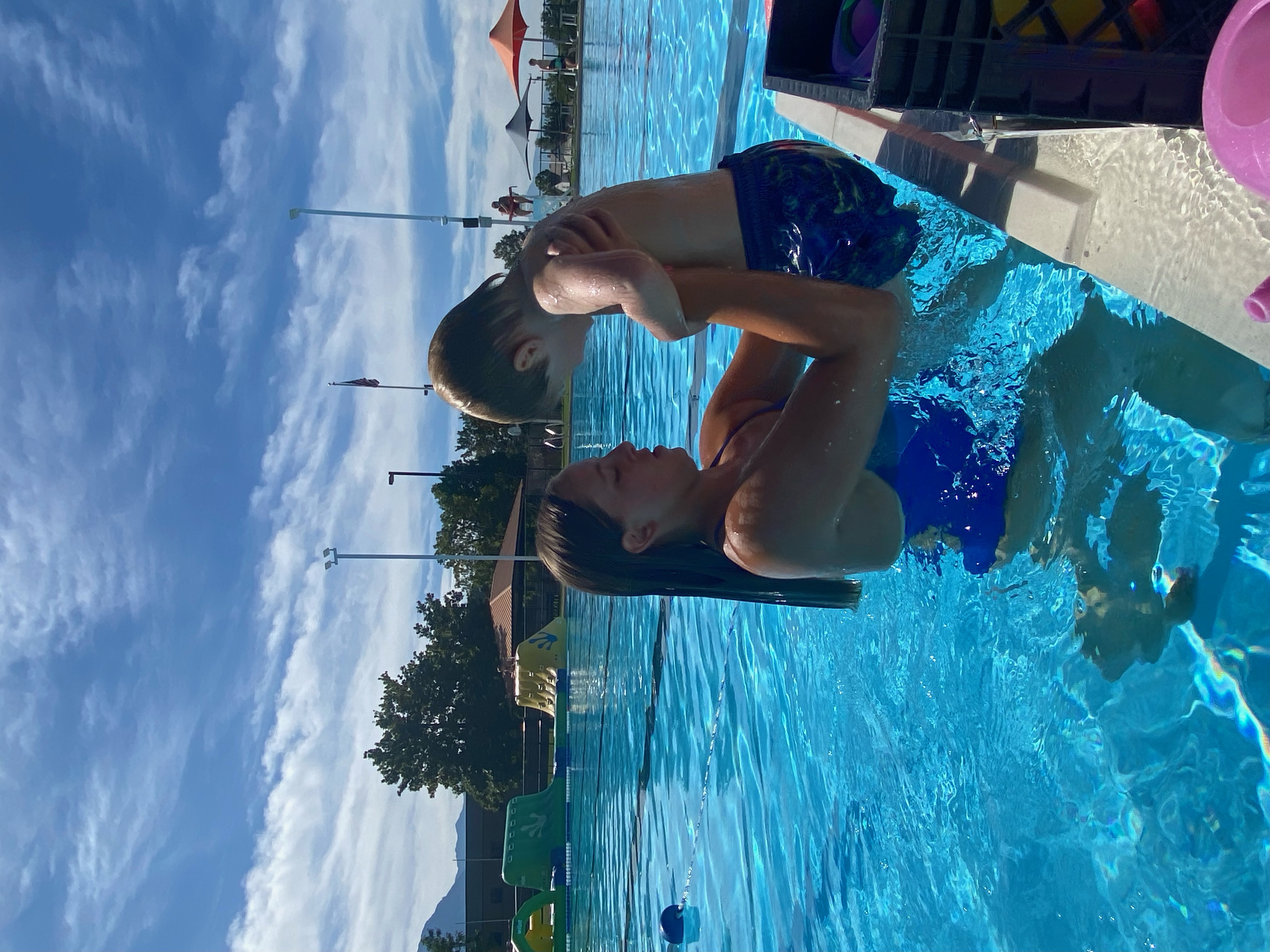 Instructor lifting a child out of the water