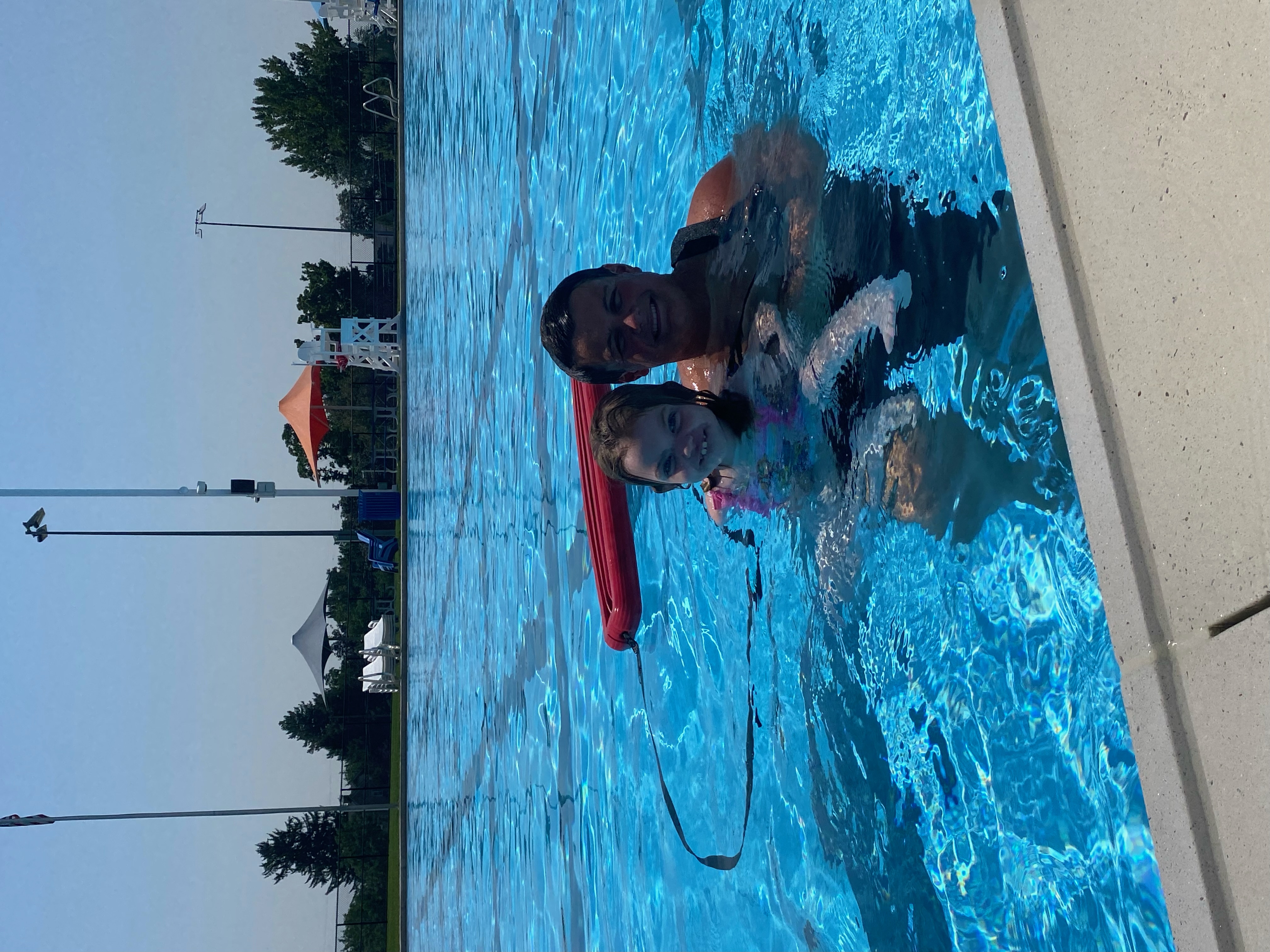 Instructor holding a child with a rescue tube