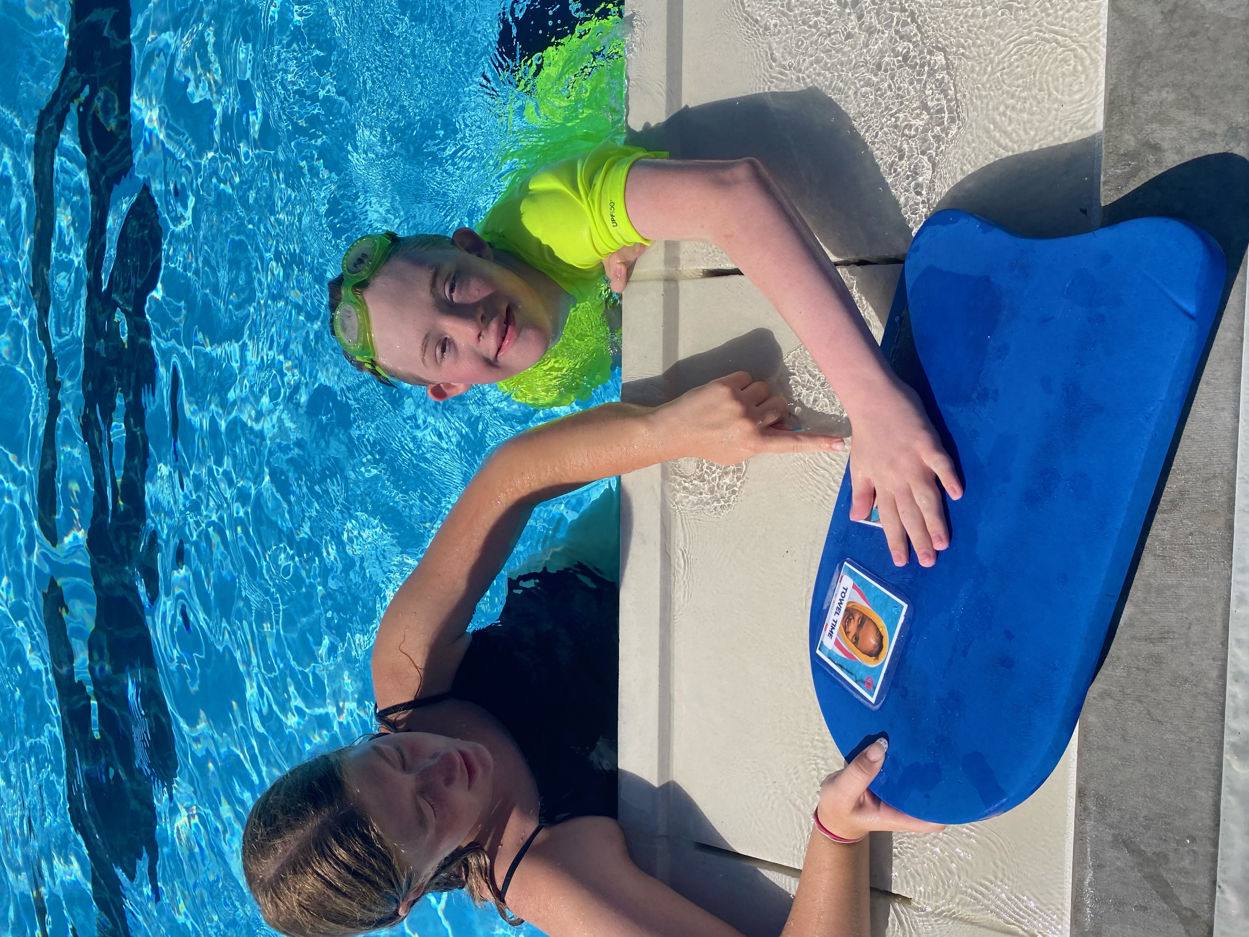 Instructor and student working at the pool edge