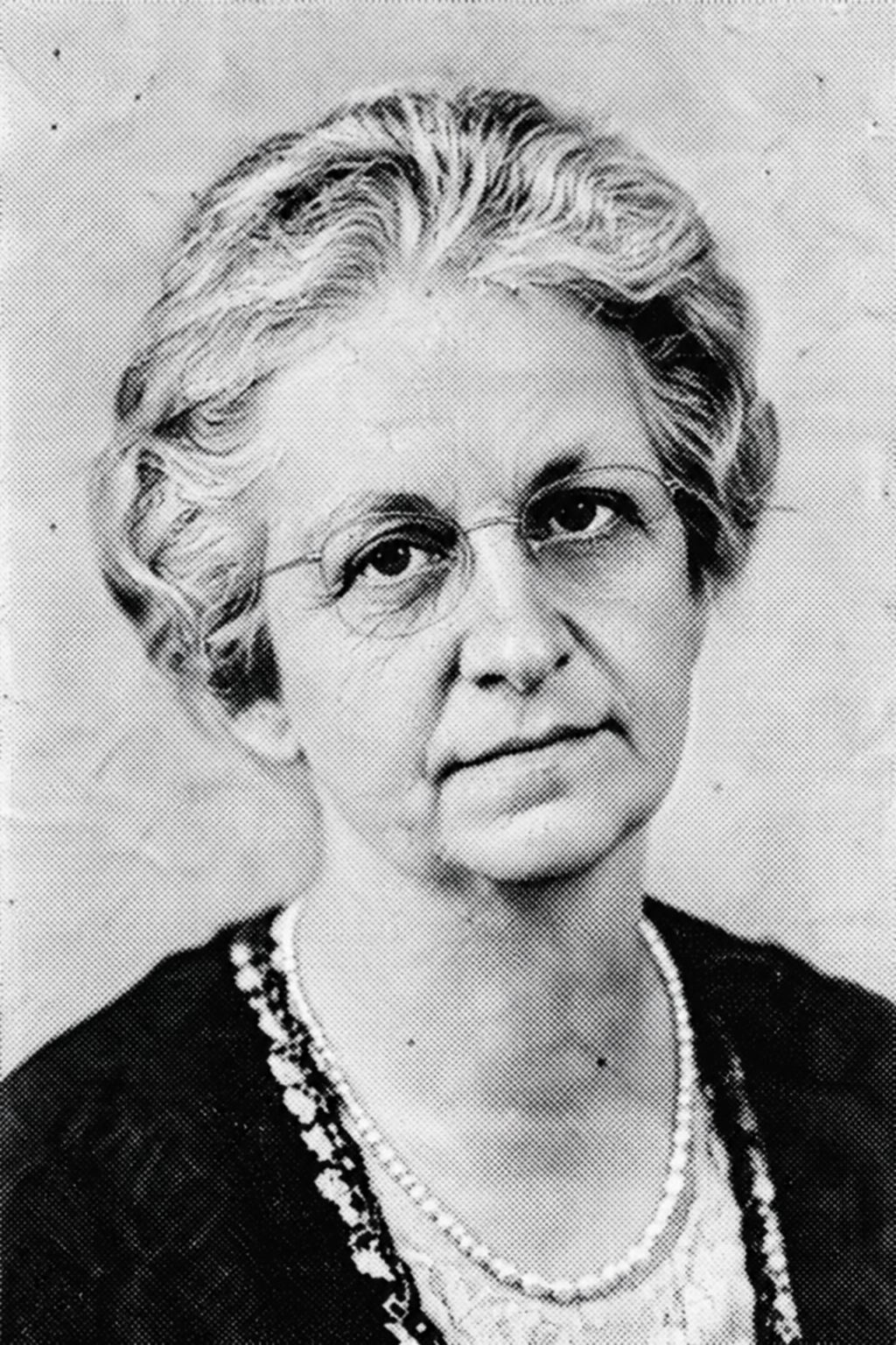 Black and white 1936 newspaper portrait of Esther Vaden wearing wire-rimmed glasses and a pearl necklace