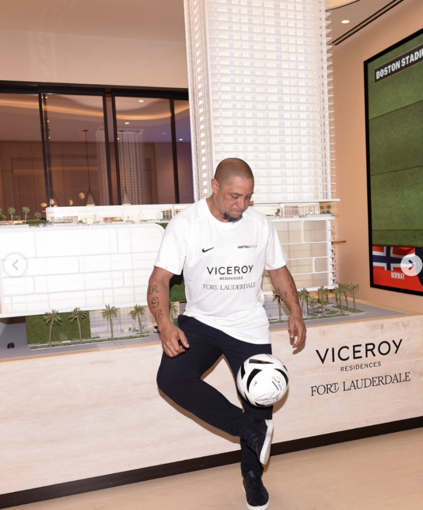 Roberto Carlos juggling a soccer ball in the Viceroy showroom