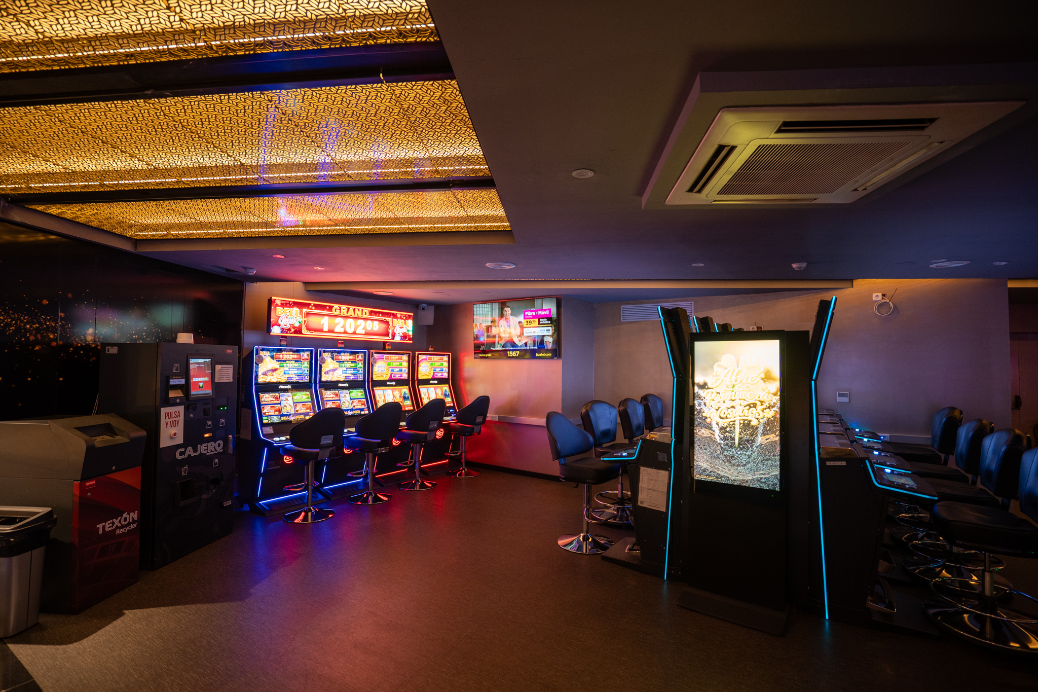 Zona de máquinas recreativas con luces de neón del Bingo Ciutat de Barcelona