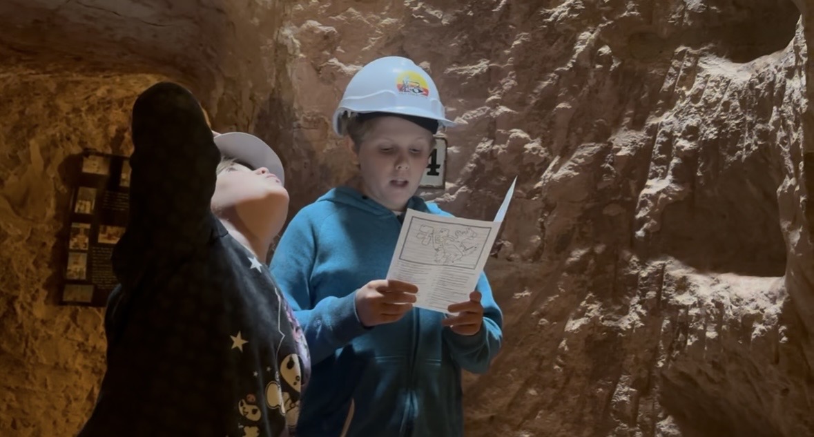 Hard hats on and black lights out, searching the walls for opal