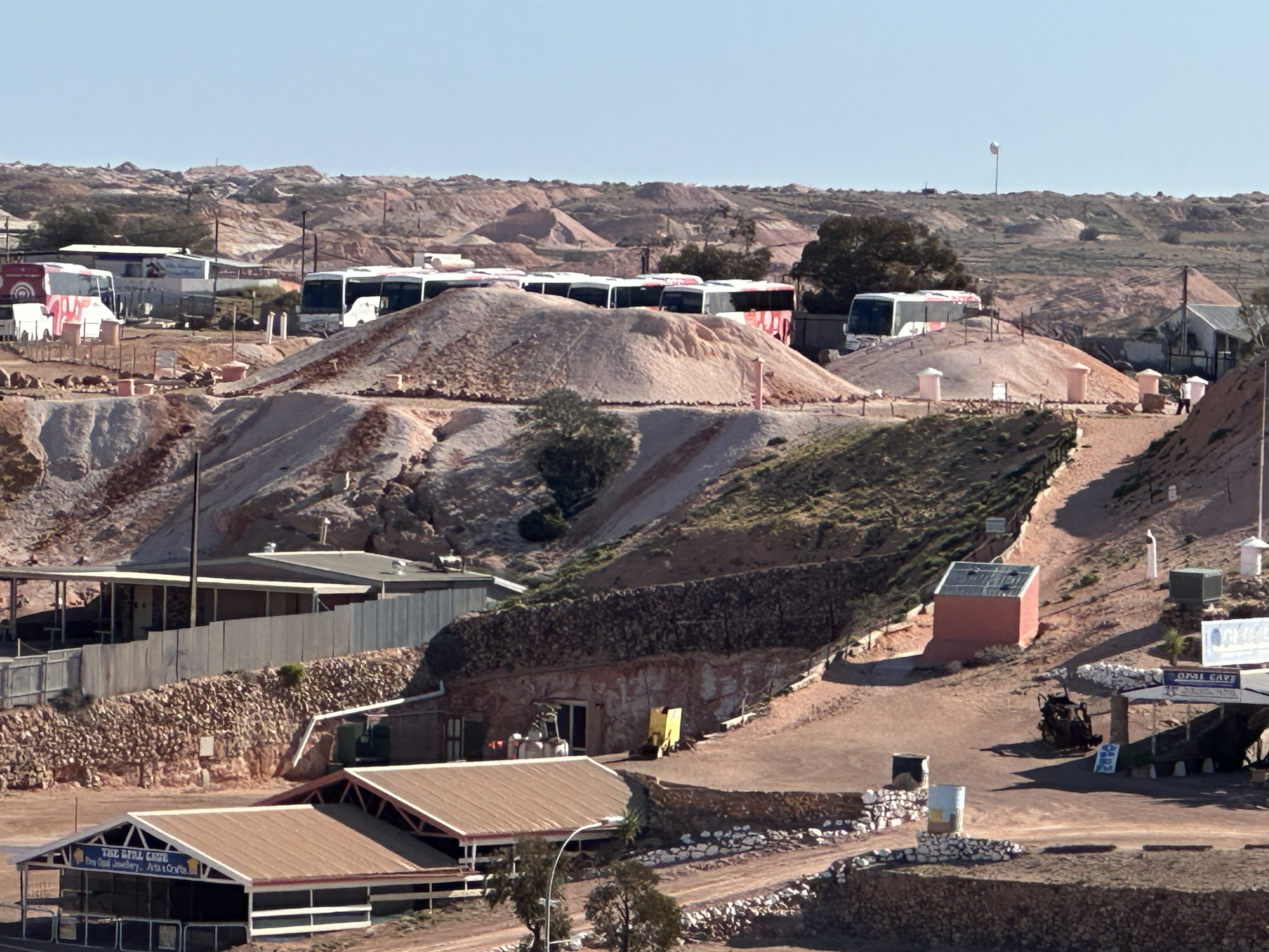 First look over Coober Pedy — dust, dirt piles and buildings that don’t quite look like anywhere else