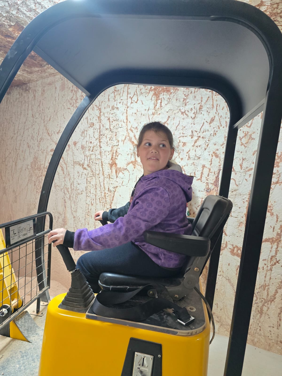 Having a go on the kid-sized machinery at Tom's Opal Mine