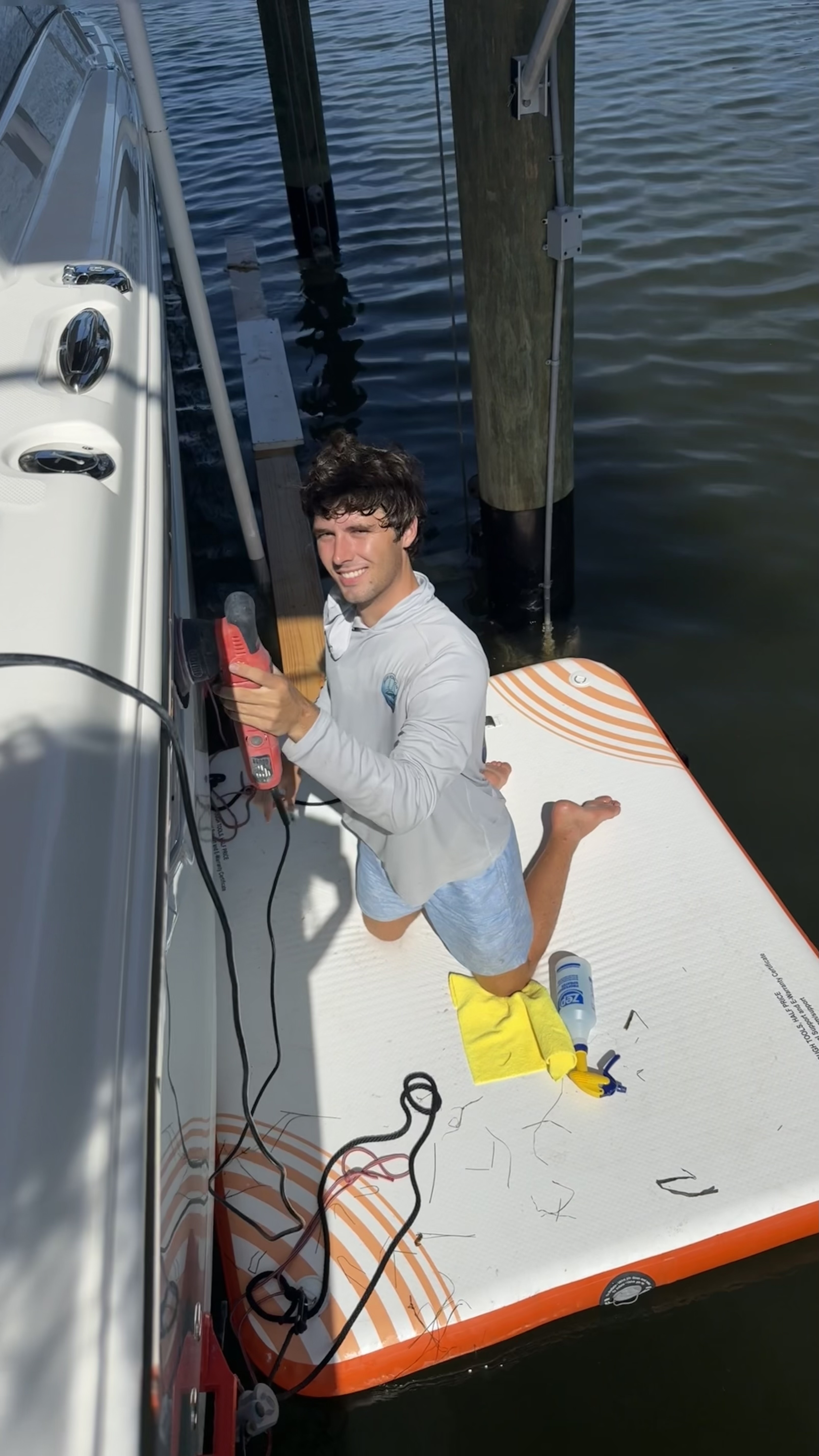 Blue Horizon Boat Detailing owner polishing a boat hull
