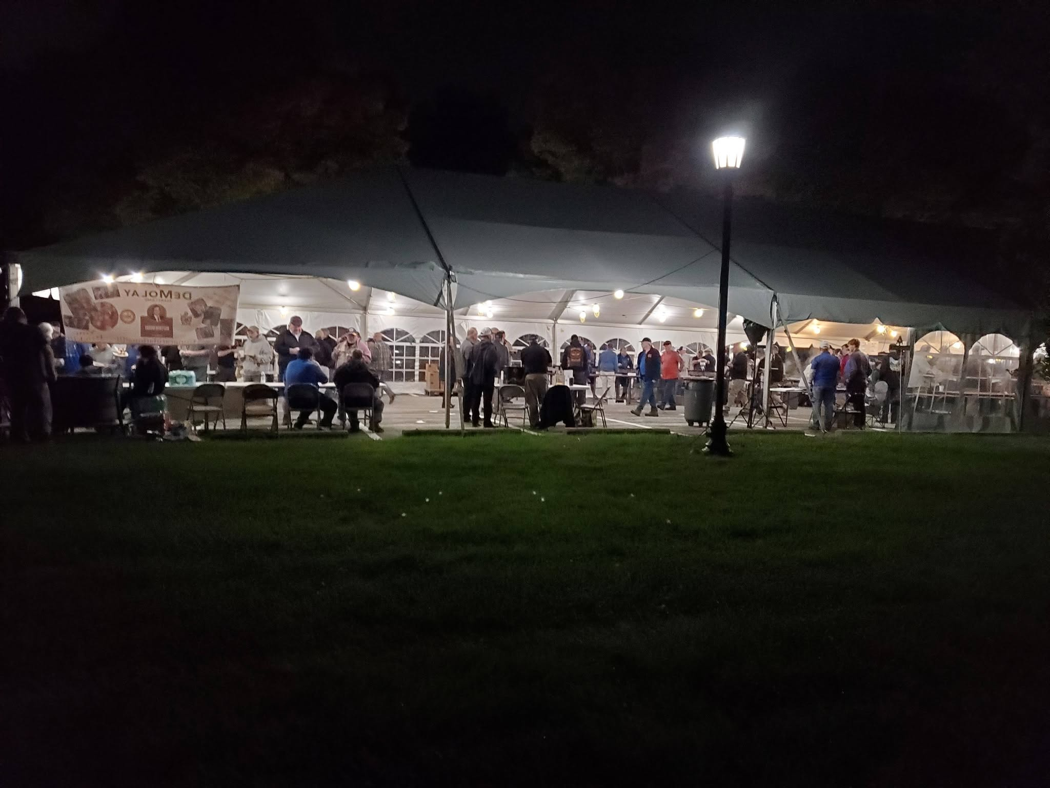 Evening fellowship beneath the illuminated Harvest Home Day tents