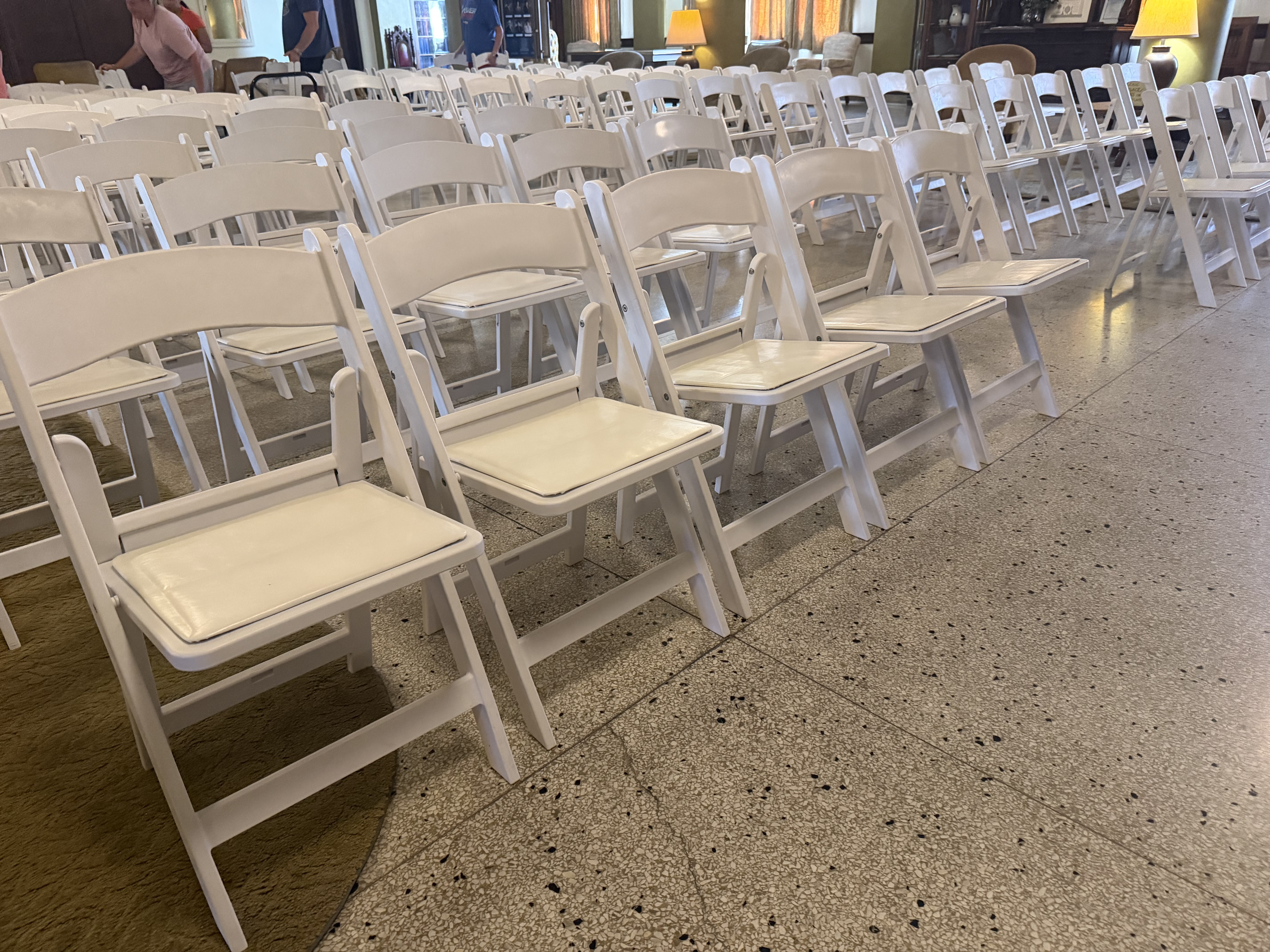 Rows of white padded chairs — venue perfection 🪑