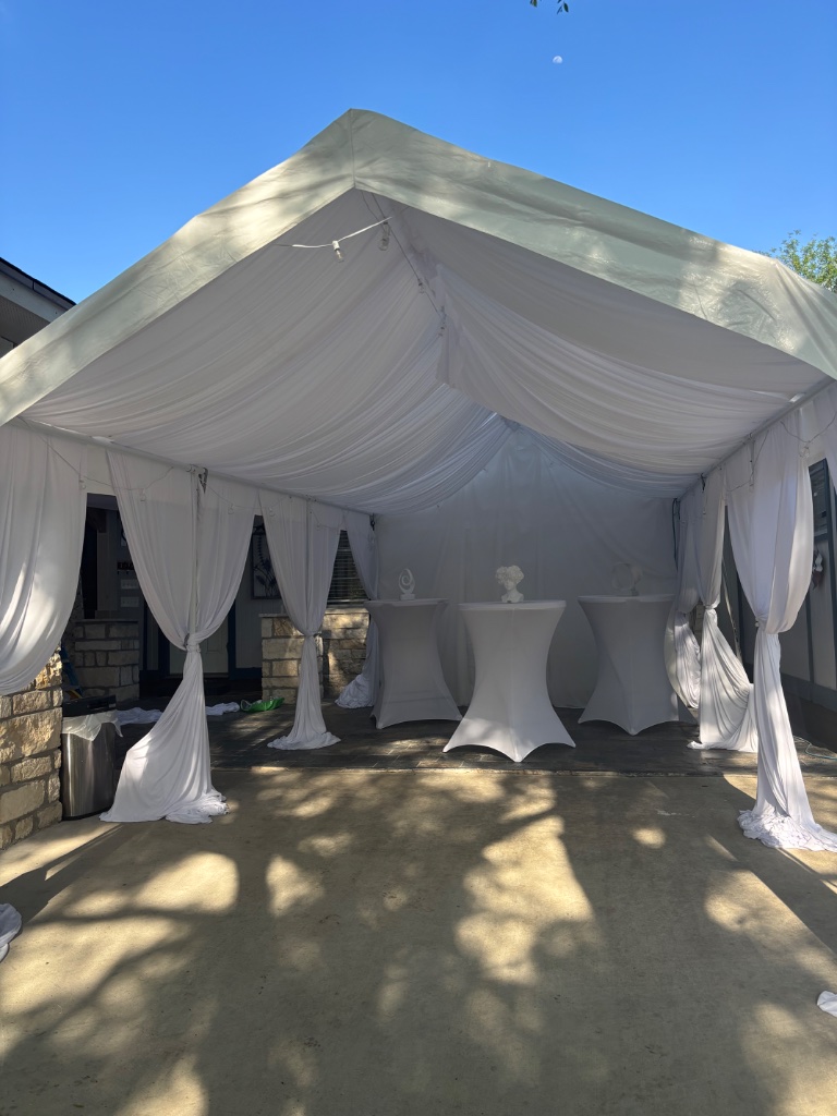 Draped white tent with cocktail tables — refined evening affair 🥂