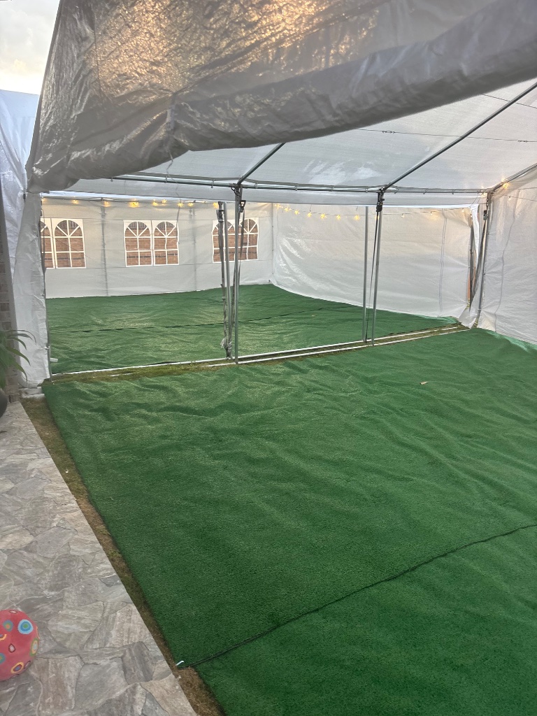 White frame tent on green turf — open, airy & stunning ⛺