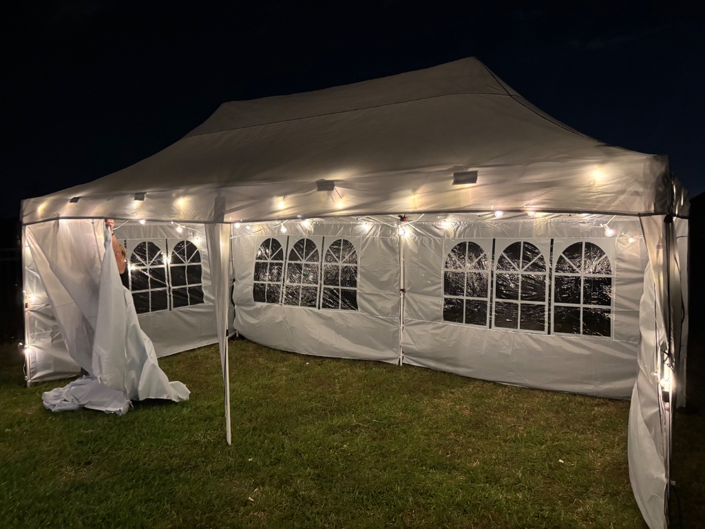 White tent with arched windows — glowing at night 🌙