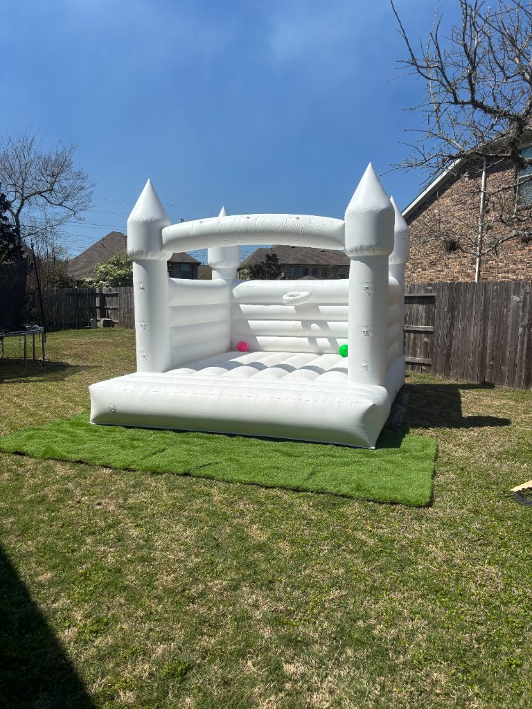 White bounce castle on lush turf — crisp & stunning 🏰
