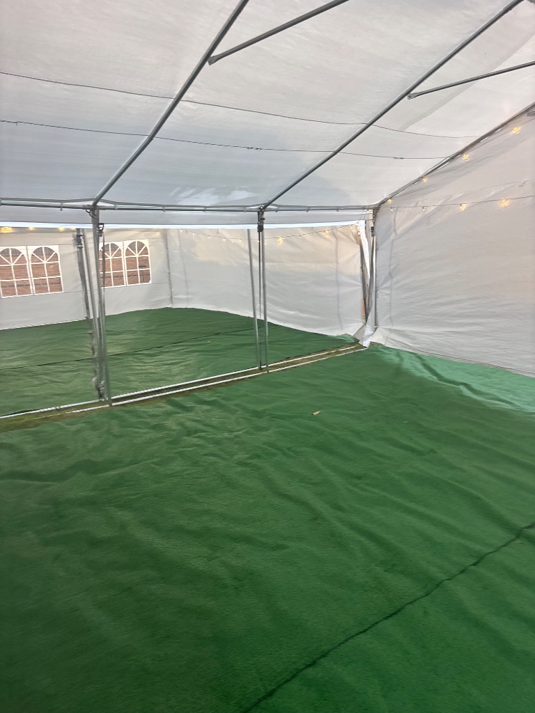 Tent with turf & string lights — golden dusk atmosphere 💡