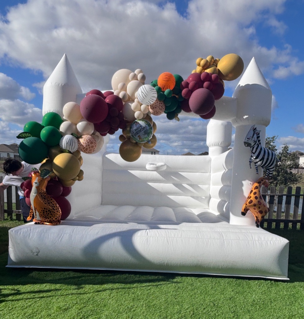 Safari bounce castle — lush jungle garland, alternate angle 🐆