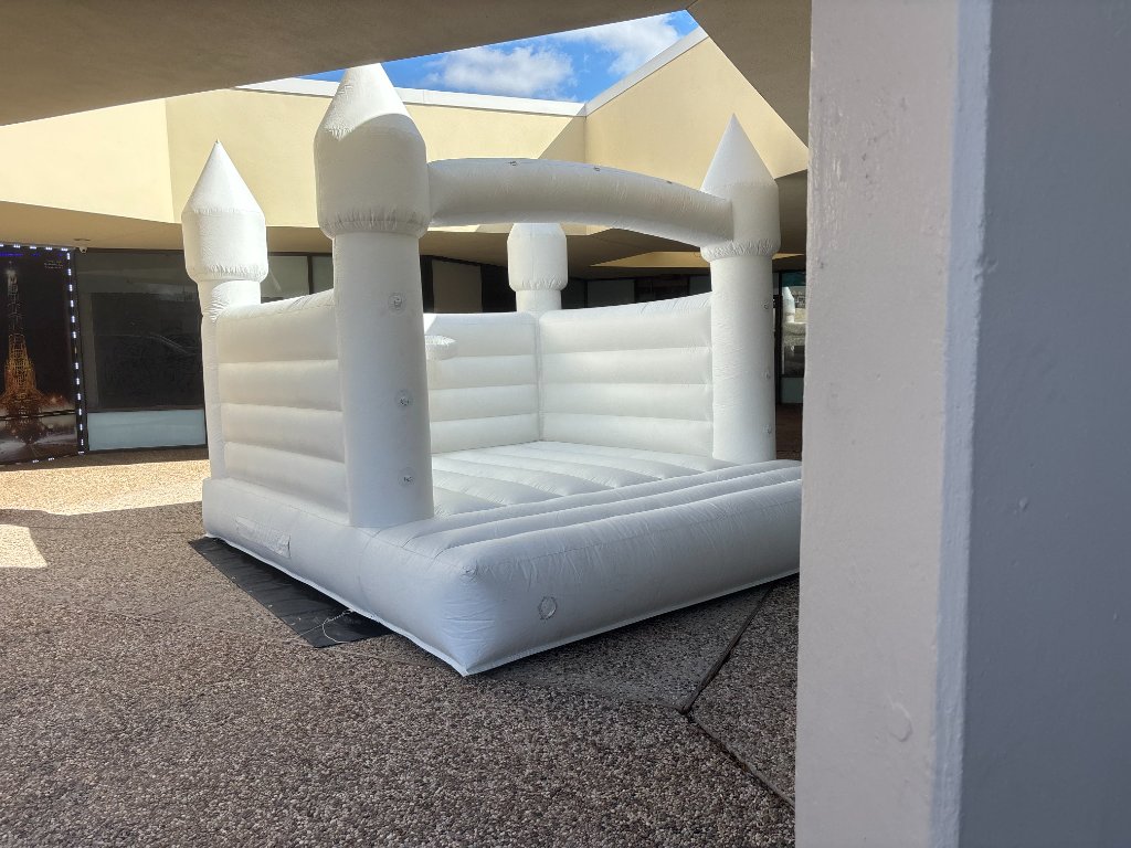 White bounce castle under covered patio 🏰