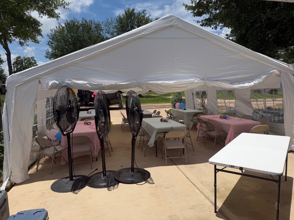 White party tent on concrete patio — fans & tables ready ⛺
