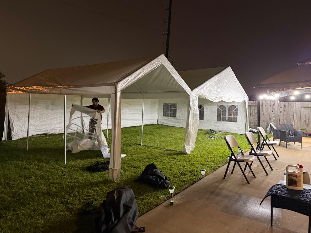 Double tent glowing at night — evening install in full swing 🌙