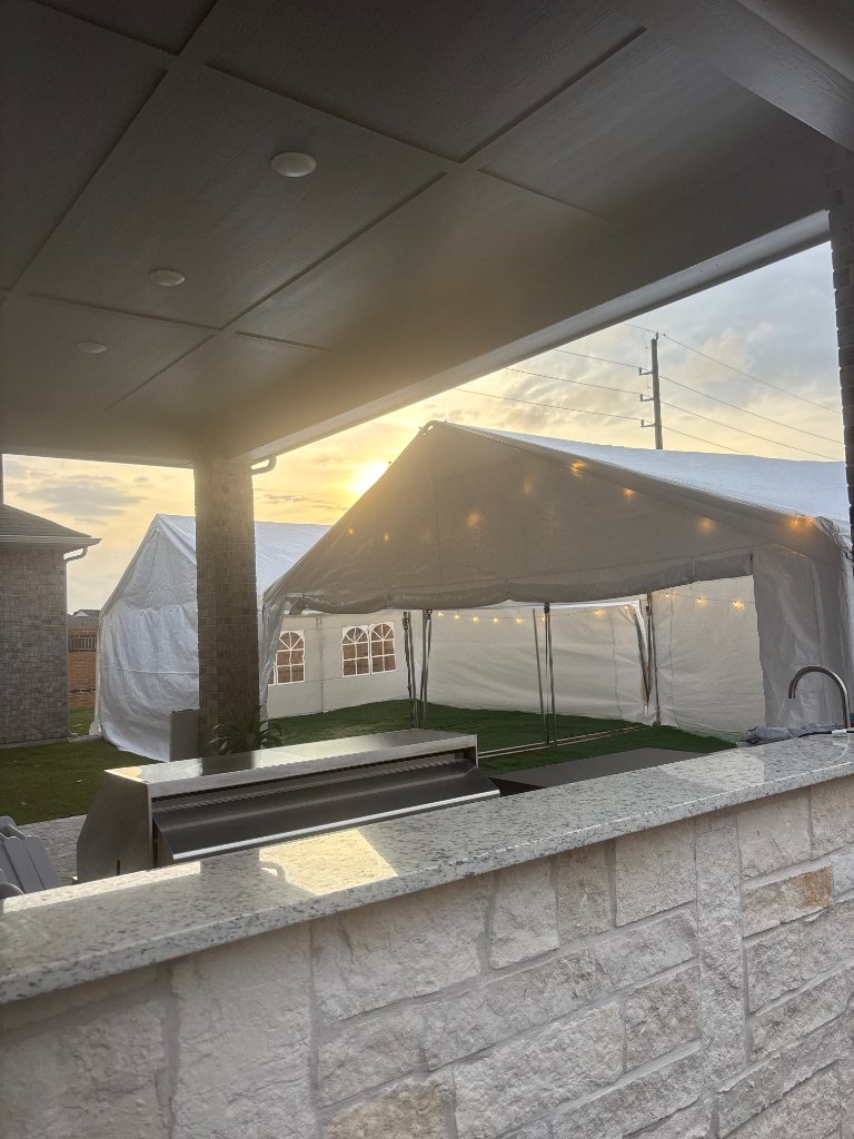 White frame tent glowing at golden hour — pure backyard magic ✨