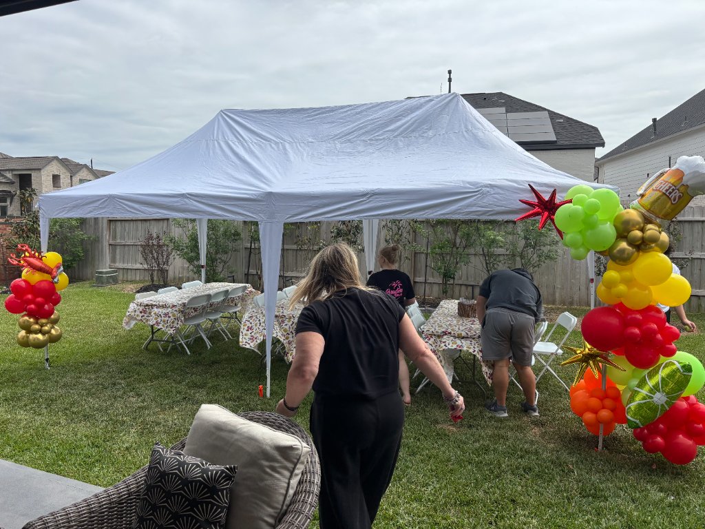 Fiesta balloon columns with festive tables under white canopy 🎉
