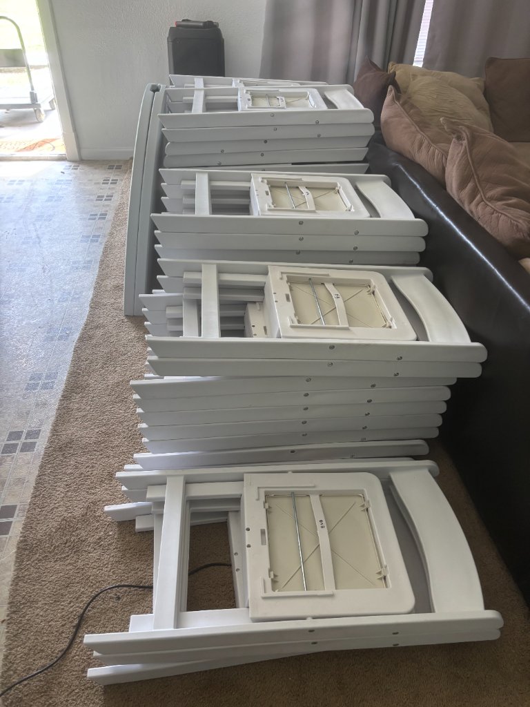 Pristine white folding chairs — delivery ready 🪑